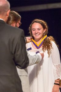 A woman receives an award