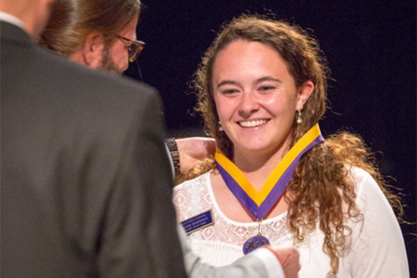 A woman receives an award