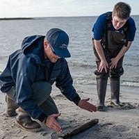 A teacher and student on a beach