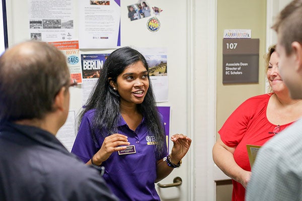 A student explains things to visitors